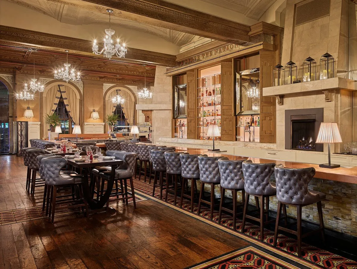 Bar stools and the long copper counter at OAK Long Bar + Kitchen