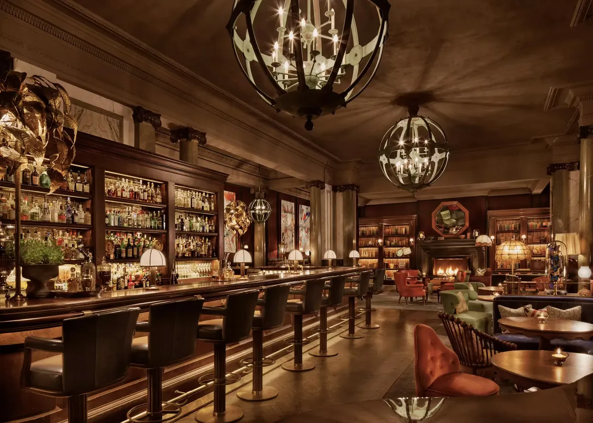 Book lined room and glowing bar at Scarfes Bar