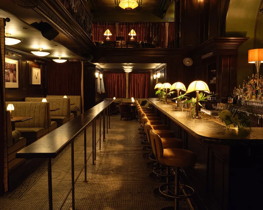Warm lamps and polished wood at the bar in Little Ned