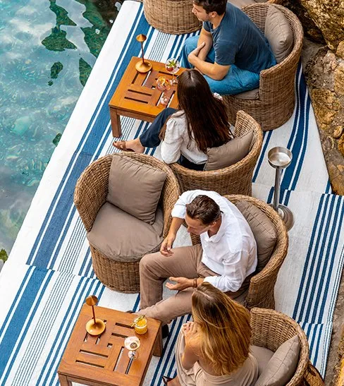 Guests seated beside the water at Le Plongeoir