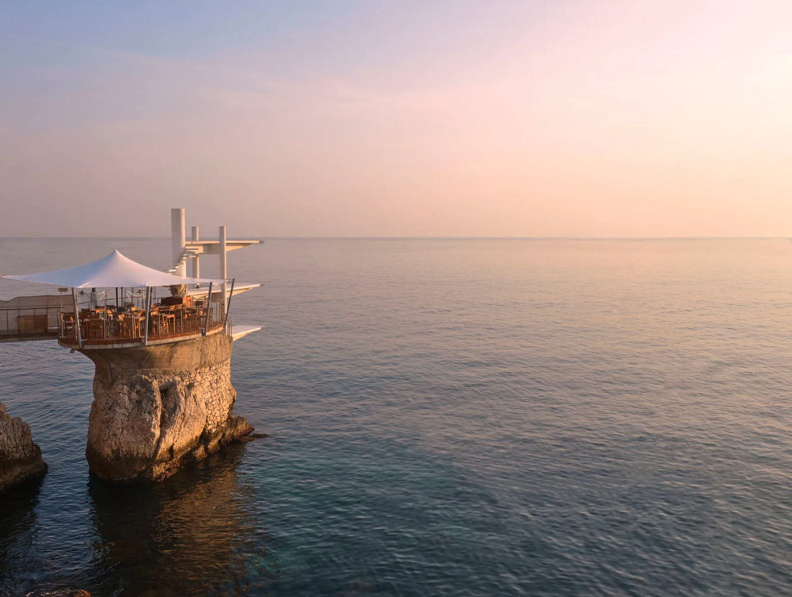 Le Plongeoir perched on rock pillars above the Mediterranean, with diving boards extending towards the sea