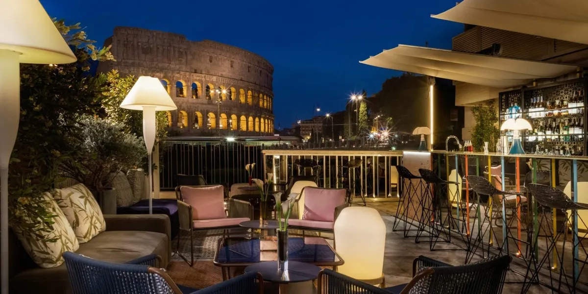 The Court terrace with the illuminated Colosseum in the background